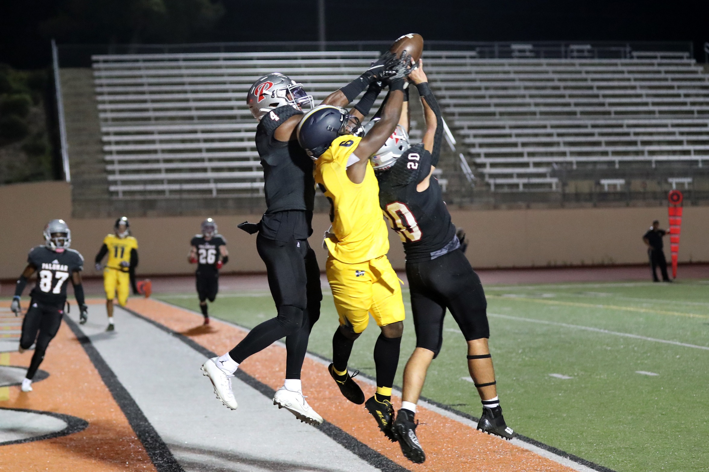 Luke Manos (No. 20) leads all Comets in tackles. Jalen Dye (No. 4) recorded two interceptions against San Diego Mesa College. Photo by Hugh Cox.