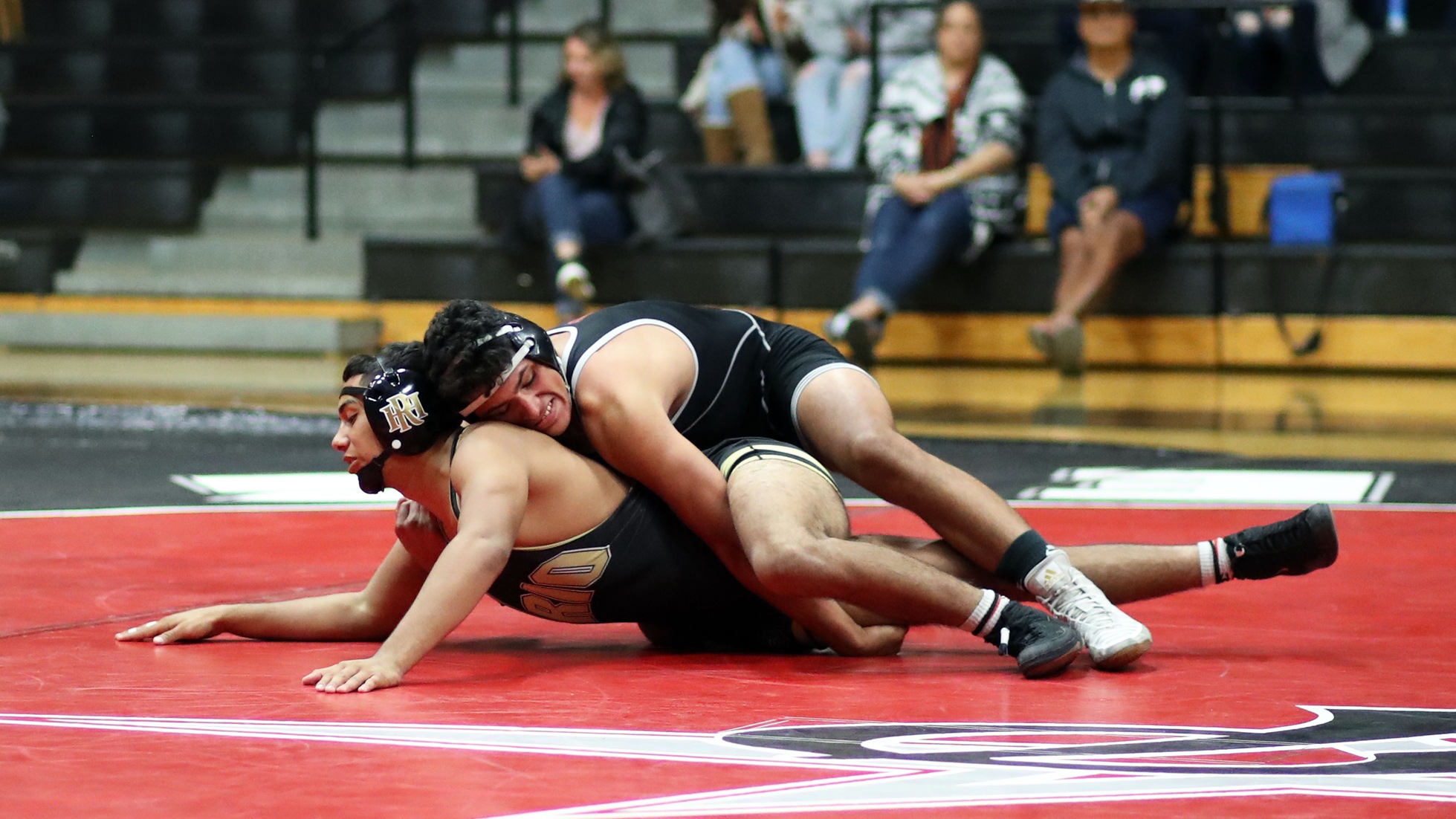 Frank Sanchez gets the two-point take down in the 165-weight class. Photo by Hugh Cox.